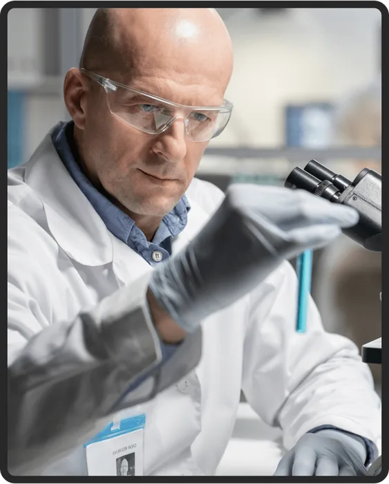 Researcher examining a sample in a lab